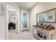 Inviting foyer with decorative door, side table, mirror and tile flooring at 507 Pamplona Pl, Davenport, FL 33837