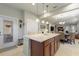 Kitchen island with granite countertop and modern lighting, adjoined by a door leading to the lanai at 507 Pamplona Pl, Davenport, FL 33837