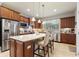 Well-lit kitchen featuring stainless steel appliances, granite countertops, and ample cabinet space at 507 Pamplona Pl, Davenport, FL 33837