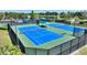 Well-maintained pickleball courts offer recreational opportunities in a scenic outdoor setting near a lake at 507 Pamplona Pl, Davenport, FL 33837