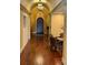 Long hallway features hardwood floors, archway, decorative lighting, and neutral paint at 5152 Conroy Rd # 1333, Orlando, FL 32811