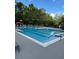 Community pool with zero entry, playground in background and lounge seating at 5152 Conroy Rd # 1333, Orlando, FL 32811