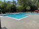 Relaxing community pool with lounge chairs and lush green landscaping at 5152 Conroy Rd # 1333, Orlando, FL 32811