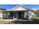 Enclosed back porch with tiled floors and screened windows overlooks the backyard at 525 Garberia Dr, Davenport, FL 33837