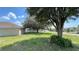 Wide backyard with mature trees provides privacy and space for outdoor enjoyment at 525 Garberia Dr, Davenport, FL 33837