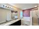 Bathroom featuring double sinks, a soaking tub, and a separate glass-enclosed shower at 525 Garberia Dr, Davenport, FL 33837