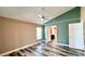 Bright bedroom with painted walls, modern ceiling fan, and wood-look tile flooring at 525 Garberia Dr, Davenport, FL 33837