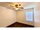 This bedroom features hardwood floors, a ceiling fan, and a window bringing in natural light at 525 Garberia Dr, Davenport, FL 33837