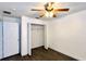 Bedroom featuring ceiling fan, closet, wood-look flooring, and two doorways at 525 Garberia Dr, Davenport, FL 33837