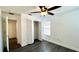 Clean bedroom featuring wood-look flooring, a ceiling fan, a closet, and an attached bathroom at 525 Garberia Dr, Davenport, FL 33837