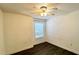 Bright bedroom with wood-look floors, a window providing natural light, and a ceiling fan at 525 Garberia Dr, Davenport, FL 33837