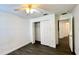 Cozy bedroom featuring wood-look floors, ceiling fan, closet, and neutral color scheme at 525 Garberia Dr, Davenport, FL 33837