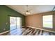 Spacious bedroom showcasing a ceiling fan, sliding glass doors to a screened lanai, and wood-look tile flooring at 525 Garberia Dr, Davenport, FL 33837