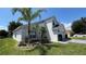 Side view of a two-story home showcasing well-maintained lawn and mature landscaping at 525 Garberia Dr, Davenport, FL 33837