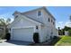 Two-story home featuring a two-car garage, neutral paint, and manicured landscaping at 525 Garberia Dr, Davenport, FL 33837