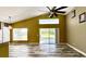 Open living room featuring vaulted ceilings, natural light, and sliding glass doors at 525 Garberia Dr, Davenport, FL 33837