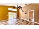 Living room featuring vaulted ceilings, neutral paint, updated fan, and access to other rooms at 525 Garberia Dr, Davenport, FL 33837