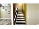 View of carpeted staircase leading to the second floor with neutral wall colors and stylish wood flooring at 525 Garberia Dr, Davenport, FL 33837