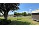 Landscaped yard with mature trees and shrubs offers privacy and curb appeal at 525 Garberia Dr, Davenport, FL 33837