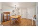 Light-filled dining area features wood floors, a vintage cabinet, and ample space for entertaining at 5463 Vineland Rd # 5107, Orlando, FL 32811