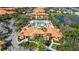 Aerial view of a multi-Gathering complex with an outdoor community pool and lush landscaping at 5463 Vineland Rd # 5107, Orlando, FL 32811