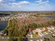 Aerial shot of a property surrounded by trees and houses in a suburban neighborhood at 563 Eagle Pointe S, Kissimmee, FL 34746