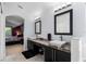 Bathroom featuring dual sinks with granite counters and a view into the bedroom at 563 Eagle Pointe S, Kissimmee, FL 34746