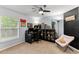 A cozy bedroom features a desk, chair, and a large bookshelf filled with toys at 563 Eagle Pointe S, Kissimmee, FL 34746