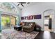 Bright living room with a sliding glass door opening to the lanai and a comfortable seating area at 563 Eagle Pointe S, Kissimmee, FL 34746