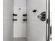 Minimalist shower with white tile and practical black shelving at 563 Eagle Pointe S, Kissimmee, FL 34746