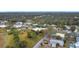 Sprawling aerial view of a residential area featuring numerous homes surrounded by trees and lawns at 6 Palm Way, Haines City, FL 33844