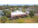 Aerial view of a well-maintained home with a neatly landscaped yard and surrounding greenery at 6 Palm Way, Haines City, FL 33844