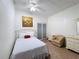 Well-lit bedroom featuring a cozy chair, ceiling fan, and a bed at 6 Palm Way, Haines City, FL 33844