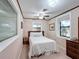 Cozy bedroom with two windows, ceiling fan, and a comfortable bed at 6 Palm Way, Haines City, FL 33844