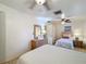 Bedroom showcasing twin beds, tile flooring, and ceiling fan with neutral decor at 6 Palm Way, Haines City, FL 33844