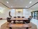 Dining room with a large table, built-in cabinets, statement lighting, and tile flooring at 6 Palm Way, Haines City, FL 33844