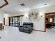 Open-concept living room with sliding glass doors, tile flooring, and comfortable seating at 6 Palm Way, Haines City, FL 33844