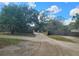 Long driveway with a fence, providing privacy and leading to a spacious property at 610 Buckley Dr, Kissimmee, FL 34741