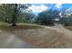 Wide driveway leading to a house, surrounded by trees, with natural landscaping creating a private entrance at 610 Buckley Dr, Kissimmee, FL 34741