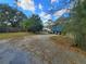 Paved driveway leading to a property, featuring a truck and surrounded by trees at 610 Buckley Dr, Kissimmee, FL 34741