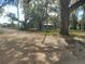 View of the house from the street, set back from the road, surrounded by mature trees at 610 Buckley Dr, Kissimmee, FL 34741