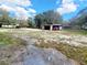 Open, partially cleared yard with a shed, providing storage and parking, surrounded by natural landscape at 610 Buckley Dr, Kissimmee, FL 34741