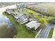 Aerial view of a home situated on a waterfront property with a lush green lawn and mature trees at 651 Glendora Rd, Kissimmee, FL 34759