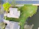 Aerial view of a home situated on a waterfront property with well-maintained landscaping at 651 Glendora Rd, Kissimmee, FL 34759