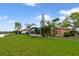 This home features a large, well-manicured lawn extending to the waterfront at 651 Glendora Rd, Kissimmee, FL 34759