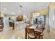 Dining room with a chandelier overlooks the kitchen with bar seating and stainless appliances at 651 Glendora Rd, Kissimmee, FL 34759