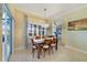 Dining area features a wood table, shuttered windows, and a slider for outdoor access at 651 Glendora Rd, Kissimmee, FL 34759