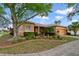 Charming single-story home with a mature tree, and colorful landscaping at 651 Glendora Rd, Kissimmee, FL 34759