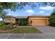 Charming single-story home featuring a well-manicured lawn and a two-car garage, with colorful landscaping at 651 Glendora Rd, Kissimmee, FL 34759