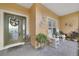 Cozy front porch with chairs and a welcome mat, framed by a decorative glass front door at 651 Glendora Rd, Kissimmee, FL 34759